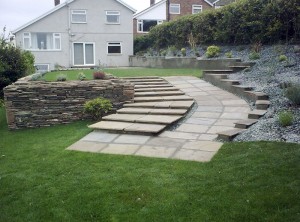 Sandstone laid ramp and steps for a Cardiff garden with freshly turfed lawn. Accessible garden design by EvergreenWales