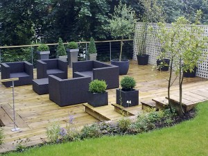 Timber decking and seating on a raised garden platform in South Wales. Survey, design and build by Evergreen Wales.