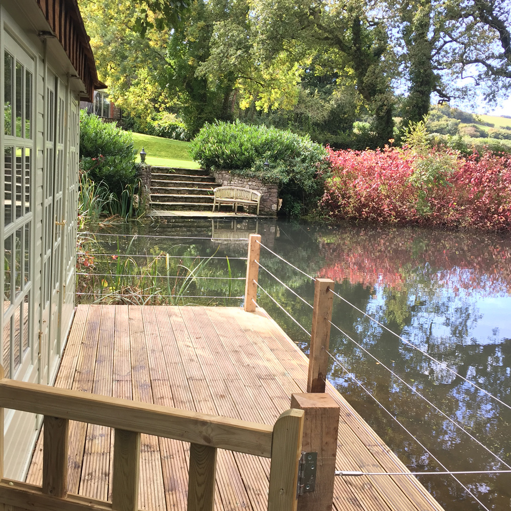 Timber house and platform on the water designed and built by Evergreen Wales in South Wales