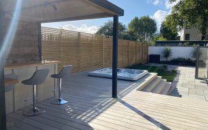 Outdoor landscaping of decking and timer work for outside bar, seating and hot tub installation by EvergreenWales in Sully, Penarth in Wales