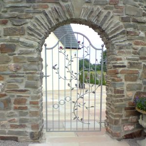 Stonework and leaf flower gate archway designed and built by Evergreen Wales