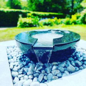 Bowl shaped water feature on stones for garden design feature, created and built by Evergreen Wales in Pentyrch