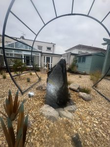 Slate water feature underneath a moon gate in a Cardiff garden. Design and build by EvergreenWales